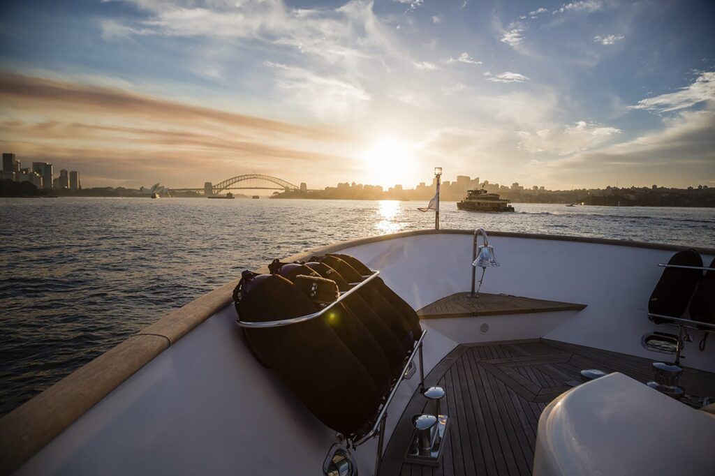 Circular quay harbour lookout: A stunning view of the Sydney Harbour at sunset, captured from the deck of a boat. The iconic